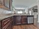 Kitchen with granite countertops and dark wood cabinets at 1510 Silver Mist Cir, Powder Springs, GA 30127