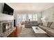 Living room with hardwood floors, fireplace and sunroom access at 907 Lenox Hill Ne Ct, Atlanta, GA 30324