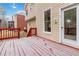 Snow covered deck with red railings and access to the house at 2155 Washington Dr, Douglasville, GA 30135