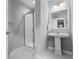 Well-lit bathroom with a pedestal sink, modern fixtures, and a tiled walk-in shower at 565 Peachtree Ne St # 804, Atlanta, GA 30308