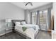 Bedroom with soft gray walls, a queen bed, neutral decor, and bright, sunlit windows at 565 Peachtree Ne St # 804, Atlanta, GA 30308