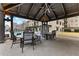 Shaded outdoor seating area with modern tables and chairs, overlooking the pool and city skyline at 565 Peachtree Ne St # 804, Atlanta, GA 30308