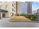 Relaxing patio space featuring a grass lawn and manicured garden with city view at 565 Peachtree Ne St # 804, Atlanta, GA 30308