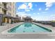 Upscale pool area featuring a sparkling pool, elegant lounge seating, and manicured landscaping at 565 Peachtree Ne St # 804, Atlanta, GA 30308