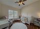 Bedroom with hardwood floors, a crib, and a window seat at 1588 School House Run, Dacula, GA 30019