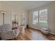 Sunlit living room with hardwood floors, large windows, and comfortable seating at 1588 School House Run, Dacula, GA 30019