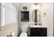 Modern bathroom with dark vanity, oval mirror, and updated shower at 219 Valerie Cir, Hiram, GA 30141