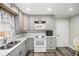 Renovated kitchen with gray cabinets and stainless steel appliances at 219 Valerie Cir, Hiram, GA 30141