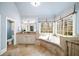 Elegant bathroom with soaking tub, double vanity, and large windows at 3173 Woodrow Ne Way, Brookhaven, GA 30319