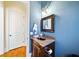 Elegant powder room with dark wood vanity and blue walls at 3173 Woodrow Ne Way, Brookhaven, GA 30319