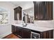 Butler's pantry with dark cabinetry and quartz countertops at 3173 Woodrow Ne Way, Brookhaven, GA 30319