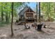 House with a fire pit and chairs in the wooded backyard at 1544 Bullard Rd, Powder Springs, GA 30127