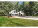 Modern farmhouse exterior with metal roof and expansive lawn at 1544 Bullard Rd, Powder Springs, GA 30127