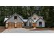 Modern farmhouse with gray siding, metal roof, and glass garage doors at 1544 Bullard Rd, Powder Springs, GA 30127