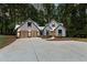 Modern farmhouse with gray siding, metal roof, and glass garage doors at 1544 Bullard Rd, Powder Springs, GA 30127