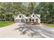 Modern farmhouse with gray siding, metal roof and glass garage doors at 1544 Bullard Rd, Powder Springs, GA 30127
