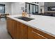 Modern kitchen island with quartz countertop and stainless steel sink at 1544 Bullard Rd, Powder Springs, GA 30127
