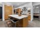 Modern kitchen with island, wood cabinets, and breakfast bar at 1544 Bullard Rd, Powder Springs, GA 30127