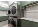 Modern laundry room with stacked washer and dryer at 1544 Bullard Rd, Powder Springs, GA 30127