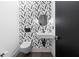 Stylish powder room featuring a feather wallpaper and a floating sink at 1544 Bullard Rd, Powder Springs, GA 30127