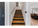 Modern staircase with sleek metal railing and dark wood steps at 1544 Bullard Rd, Powder Springs, GA 30127