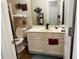 Bathroom with a toilet, sink, and decorative accents at 1077 Balvaird Dr, Lawrenceville, GA 30045