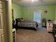 Bedroom with queen-size bed and light green walls at 1077 Balvaird Dr, Lawrenceville, GA 30045