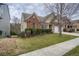 Side view of house showcasing landscaping and driveway at 1077 Balvaird Dr, Lawrenceville, GA 30045