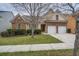 Brick house with two-car garage and landscaped lawn at 1077 Balvaird Dr, Lawrenceville, GA 30045