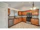 Kitchen with wood cabinets, granite counters, and stainless steel appliances at 1077 Balvaird Dr, Lawrenceville, GA 30045