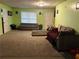 Spacious living room with light green walls and neutral carpeting at 1077 Balvaird Dr, Lawrenceville, GA 30045