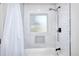 Bathroom with subway tile shower/tub combo, and a frosted window for natural light at 1430 New Hope Church Rd, Loganville, GA 30052