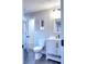 Modern bathroom with gray textured wallpaper, white vanity, and dark gray floor tiles at 1430 New Hope Church Rd, Loganville, GA 30052