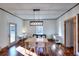 Bright dining room features hardwood floors, a farmhouse table, and a modern chandelier at 1430 New Hope Church Rd, Loganville, GA 30052