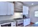 Kitchen with white cabinets, granite countertops, and a rustic range hood at 1430 New Hope Church Rd, Loganville, GA 30052