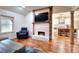 Living room with fireplace, hardwood floors, and kitchen view at 1430 New Hope Church Rd, Loganville, GA 30052