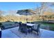 Patio dining area with seating for six under an umbrella at 1430 New Hope Church Rd, Loganville, GA 30052