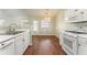 View of kitchen with white cabinets and hardwood floors at 2490 Insdale Nw Trce, Acworth, GA 30101