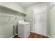 Laundry room with washer, dryer, and ample shelving at 2490 Insdale Nw Trce, Acworth, GA 30101