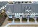 Aerial view of townhouses; showing building exteriors, landscaping, and parking at 5215 Riden Ct, Buford, GA 30518