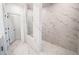 Bathroom with walk-in shower and marble tile at 5215 Riden Ct, Buford, GA 30518