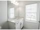 Simple bathroom with white vanity and marble-look floors at 5215 Riden Ct, Buford, GA 30518