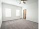 Spacious bedroom with ceiling fan and carpet flooring at 5215 Riden Ct, Buford, GA 30518