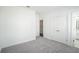 Spacious bedroom with grey carpet and double doors at 5215 Riden Ct, Buford, GA 30518