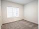 Bright bedroom featuring gray carpet and a large window at 5215 Riden Ct, Buford, GA 30518