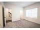 Simple bedroom with gray carpeting and a window at 5215 Riden Ct, Buford, GA 30518