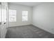 Bright bedroom with grey carpet and two windows at 5215 Riden Ct, Buford, GA 30518