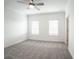 Bright bedroom with ceiling fan, carpet, and two windows at 5215 Riden Ct, Buford, GA 30518