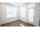 Well-lit dining area with wood-look floors and access to a deck at 5215 Riden Ct, Buford, GA 30518