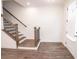 Modern entryway featuring a staircase with dark wood railing and wood-look floors at 5215 Riden Ct, Buford, GA 30518